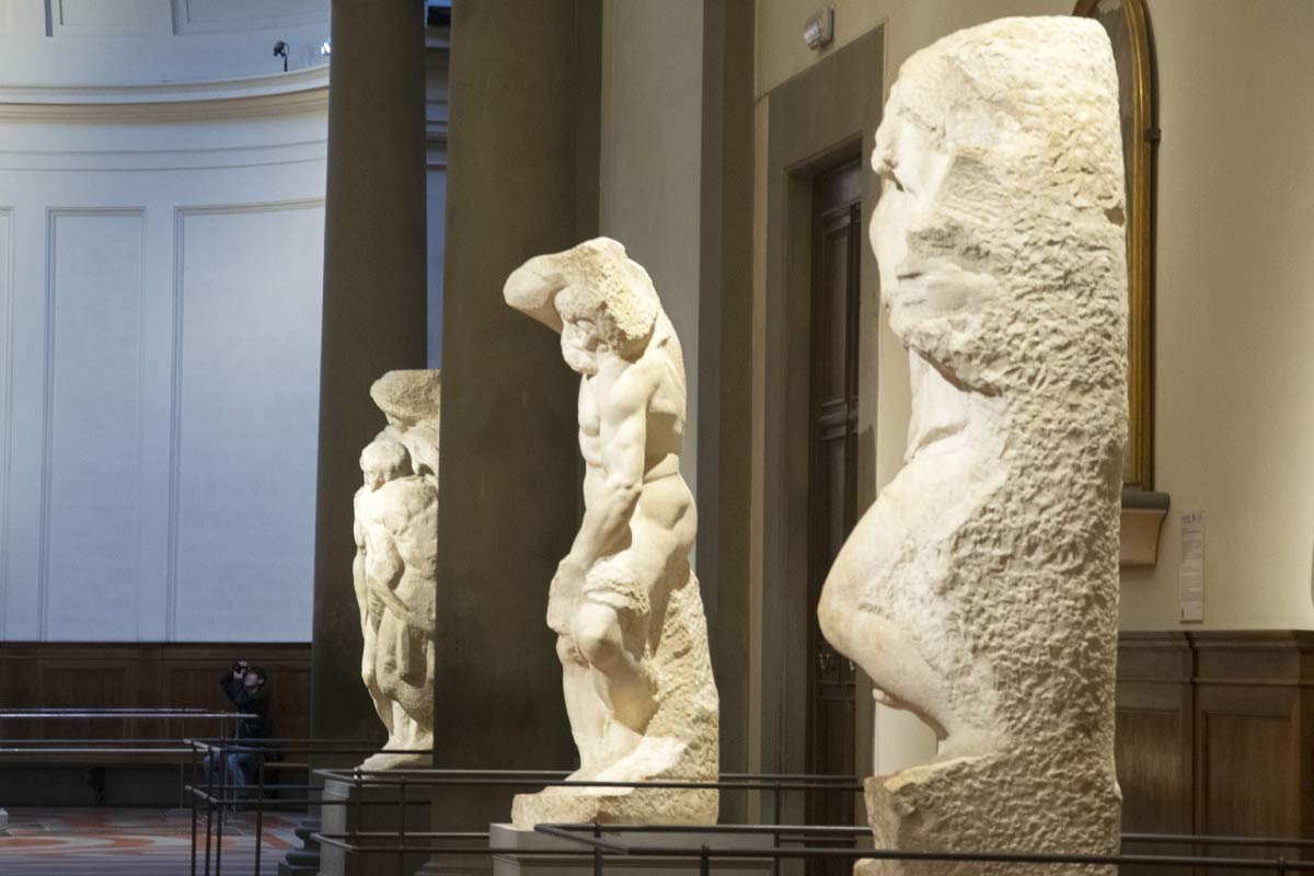 Michelangelo's unfinished Prisoners sculptures emerging from marble at Accademia Gallery