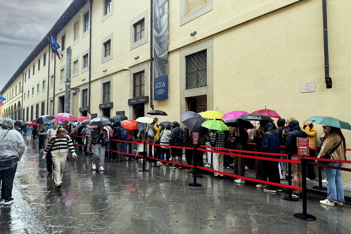 Typical visitor queue at Accademia Gallery entrance during peak hours