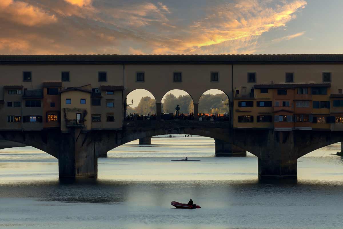 Ponte Vecchio at sunset golden hour romantic view Florence Italy