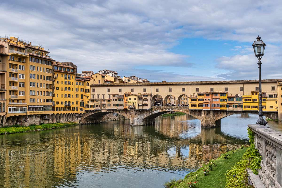 Scenic Arno River view from Ponte Vecchio bridge looking toward other Florence bridges