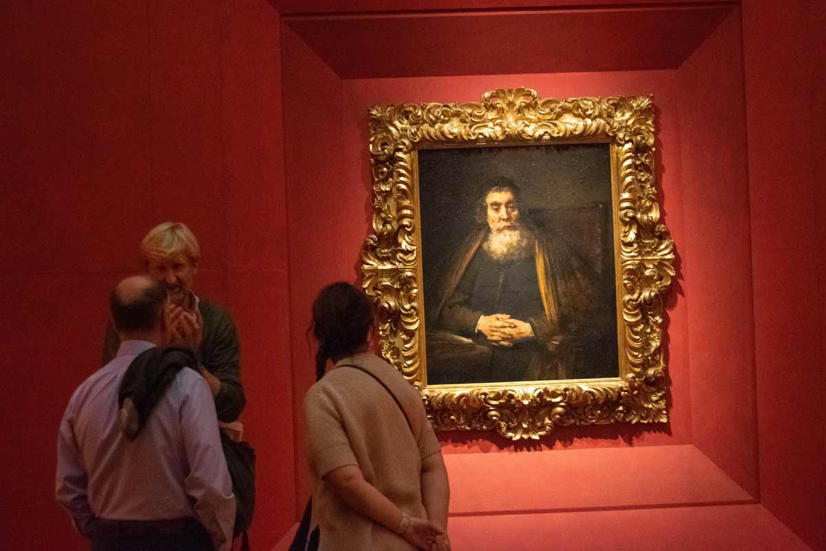Visitor viewing Renaissance art at Uffizi Gallery Florence with audio guide engaged experience